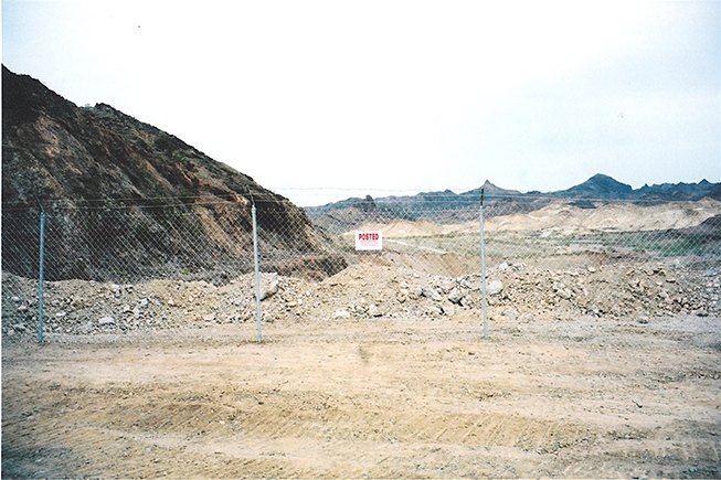 View looking north of the fenced open pit area of mine.